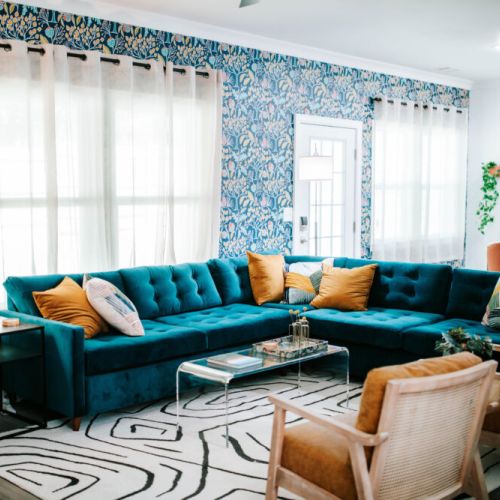 Lounge in luxe on this plush velvet sectional, surrounded by lush wallpaper and natural light. A stylish escape made for cozy hangs and photo ops!