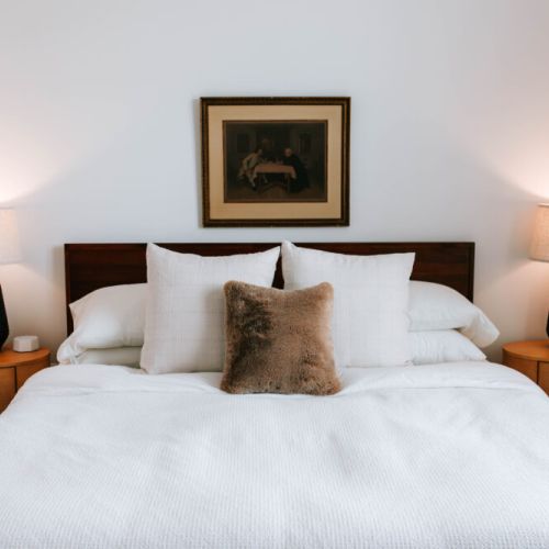 Relax and recharge in this cozy bedroom featuring a plush bed, soft lighting, and calming decor — your perfect retreat after a day of adventure.