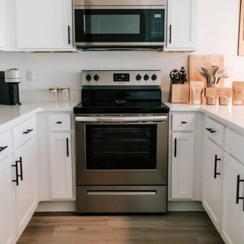 Welcome to the heart of culinary inspiration!  Step into our modern kitchen, adorned with sleek stainless steel appliances that gleam with possibility. This snapshot captures the essence of gourmet convenience, where every tool and ingredient awa