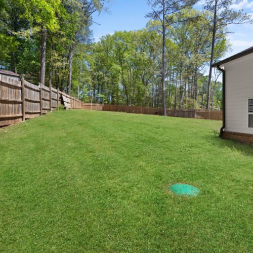 This spacious, fenced-in backyard is perfect for morning yoga or epic family games. Serenity meets space in your private outdoor retreat!