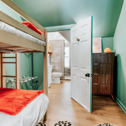 Give kids or extra guests a comfortable retreat with twin bunk beds, a wall-mounted TV, convenient storage, and a nearby bathroom. This thoughtfully connected setup makes getting ready, relaxing, and settling in easy for groups and families.