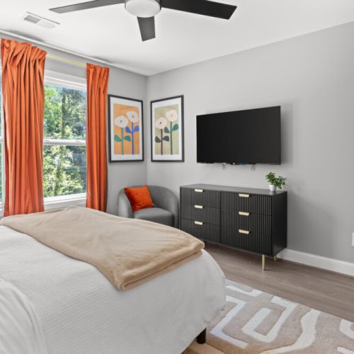Unwind in style with a plush bed, sleek decor, and sunshine pouring in from forest-lined windows—your peaceful escape awaits!