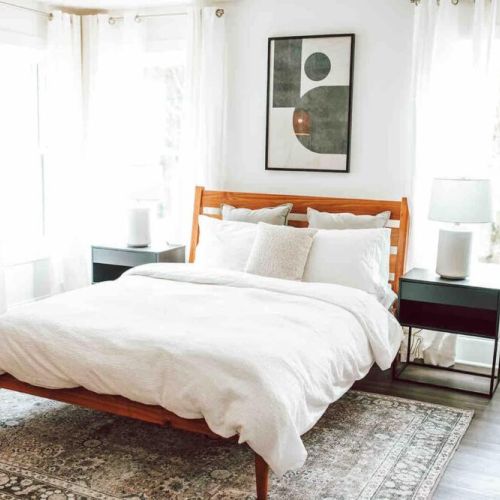 Primary bedroom featuring a queen sized Purple mattress, en-suite bathroom, and Lux organic linens.