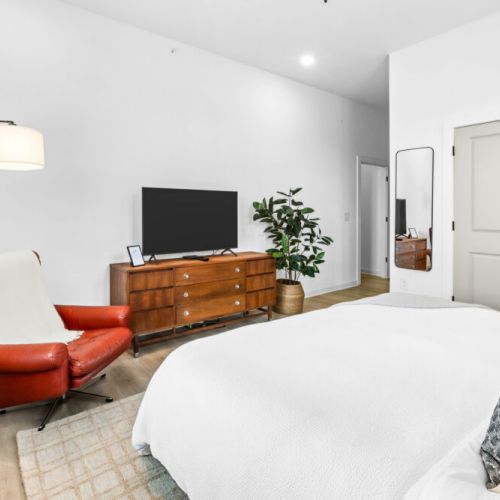 Relax in style: bedroom number two offers a spacious retreat with a comfortable queen-sized bed, promising a restful night's sleep in a cozy setting.