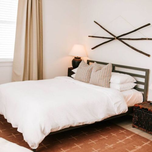 In every bedroom, you'll find a queen-sized Purple Mattress accompanied by organic Supima cotton linens and a duvet. Rest assured that each element of bedding, including throw pillows and blankets, undergoes meticulous sanitization between every gues