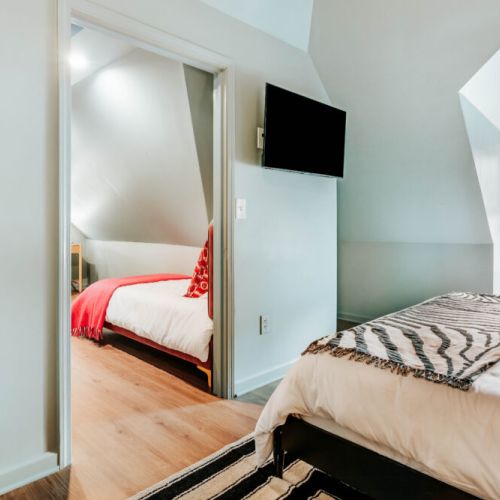Enjoy added privacy and flexibility with adjoining sleeping spaces, crisp linens, and a wall-mounted TV. The connected layout makes it easy for families or groups to stay close while still having room to unwind and recharge.