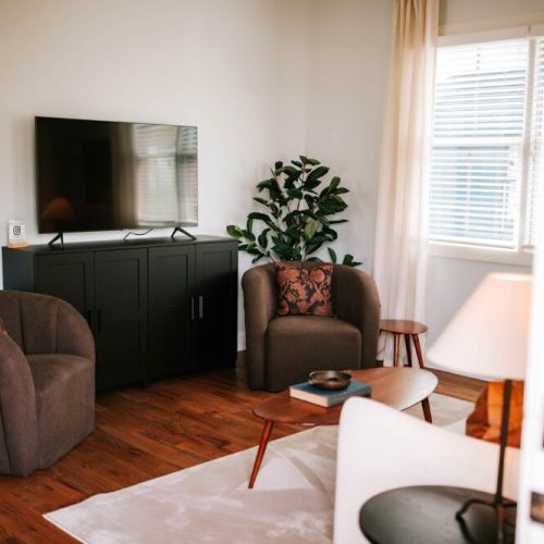 Unwind in our cozy living room, equipped with a 55" flat-screen TV, offering a perfect retreat for our guests to relax and enjoy during their stay