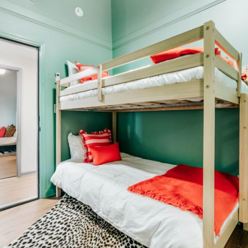Give the kids or extra guests a fun space of their own with twin bunk beds, crisp linens, and cheerful pops of color.