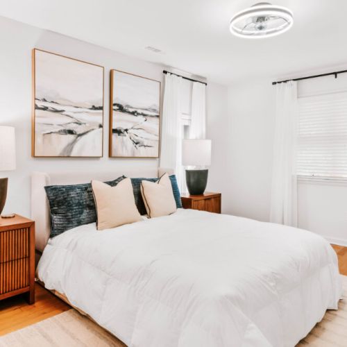 Comfortable bedroom with plush bedding, warm lighting, and peaceful décor for a restful stay.