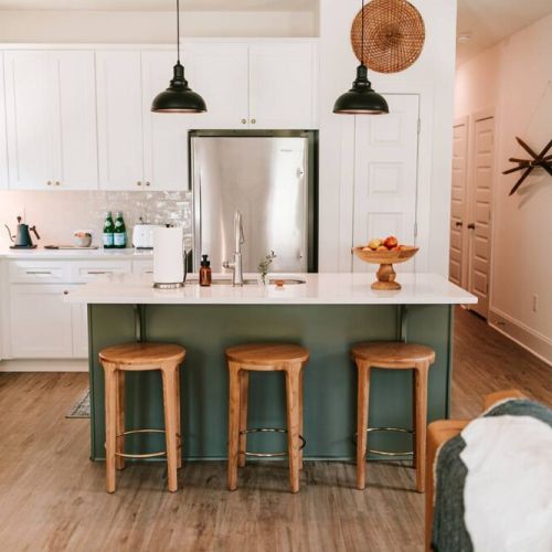 Fully stocked kitchen with bar seating for three.