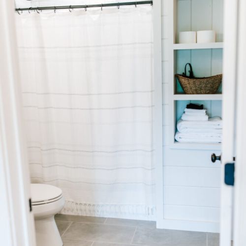 Bright and spotless full bathroom with fresh towels and essential toiletries, ready for your stay.