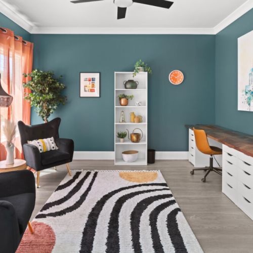 This vibrant lounge-workspace hybrid is bursting with color, style, and cozy vibes—perfect for remote work or a good book in hand.