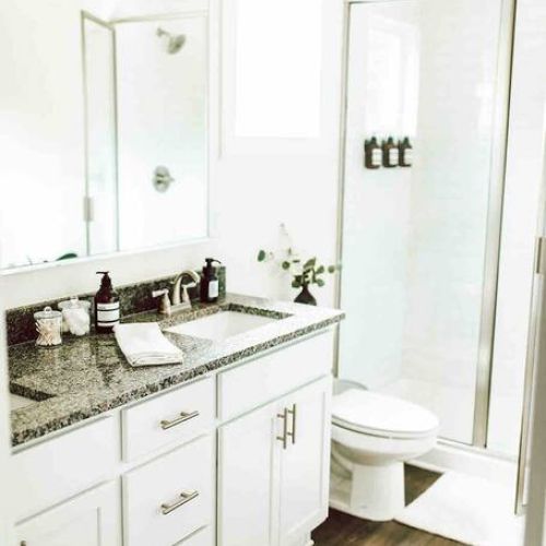 Indulge in luxury: this en-suite bathroom features a double vanity, offering ample space for you to pamper yourself and unwind in style.
