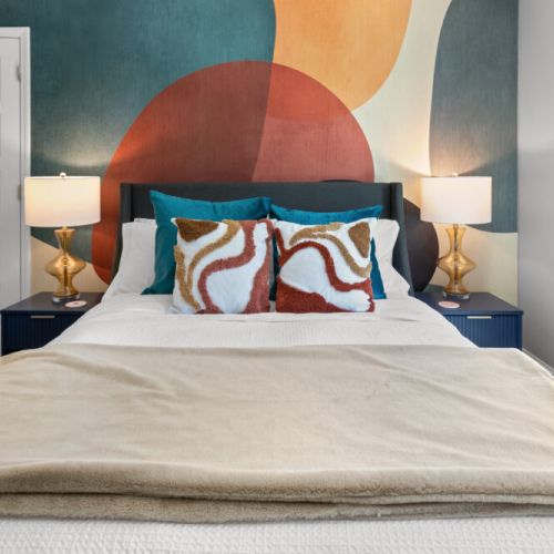 Wake up to color, comfort, and sunlight—this vibrant bedroom is where playful design meets peaceful rest.