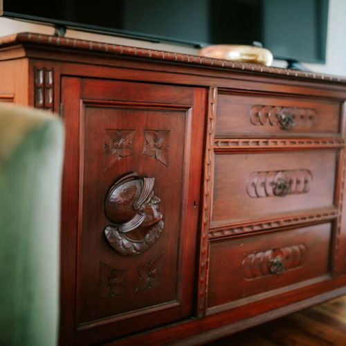 Add a touch of charm to your stay! Our room features an antique sideboard, adding character and style to your retreat.