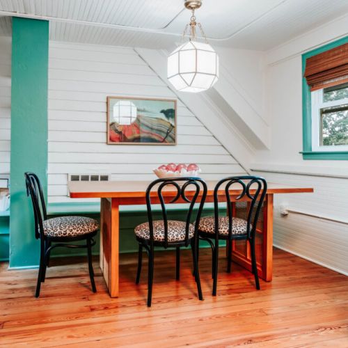 Gather around the dining table for morning coffee, shared meals, or late-night conversation. Warm wood floors, natural light, and playful details create an inviting setting to slow down, connect, and enjoy time together.