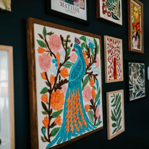 Step into a curated gallery wall bursting with bold colors and vibrant textures—featuring peacocks, petals, and patterns that pop. This home doesn’t just host you, it inspires you.